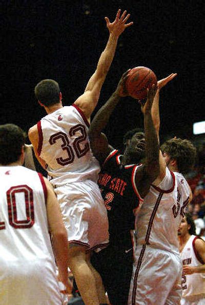 
Center John Ofoegbu goes up against Cougar defenders. 
 (Associated Press / The Spokesman-Review)