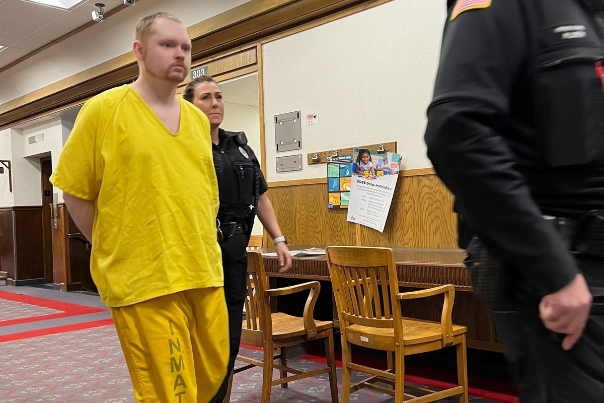 Spokane County corrections officers escort Richard S. Hough, 30, into Judge Annette Plese’s courtroom on Thursday morning.  (Photo by Quinn Welsch )