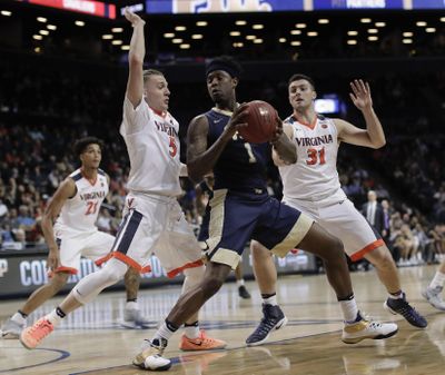 Pittsburgh forward Jamel Artis (1) is double teamed by Virginia guard Kyle Guy (5) and Virginia forward Jarred Reuter (31) during the first half of an NCAA college basketball game in the second round of the ACC tournament, Wednesday, March 8, 2017, in New York. (Julie Jacobson / Associated Press)