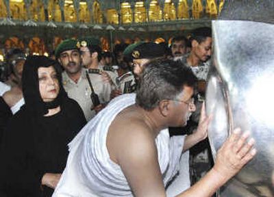 
Pakistan's President Gen. Pervez Musharraf kisses Hajr-e-Aswad, the sacred stone,  Tuesday in Mecca, Saudi Arabia. Associated Press
 (Associated Press / The Spokesman-Review)