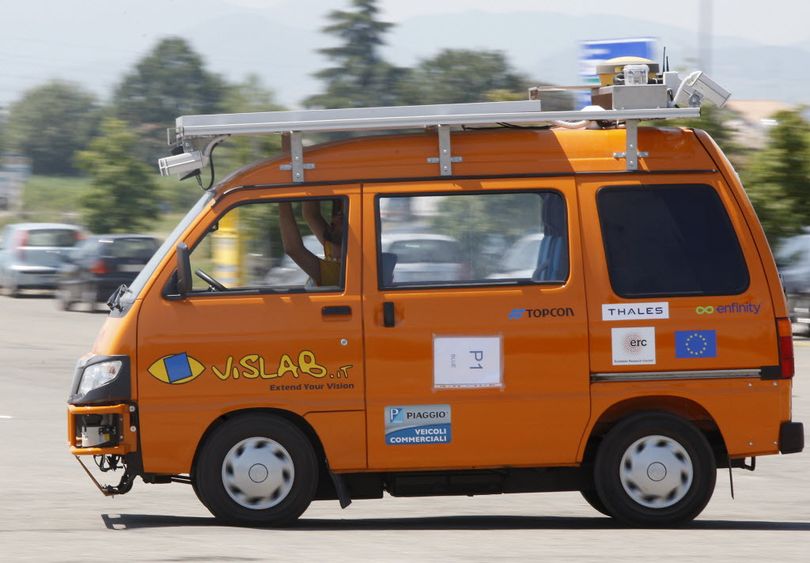 In this 2010 photo, an unmanned electric-powered vehicle makes its way down a street in Parma, Italy, part of its three-month, 8,000-mile road trip from Europe to China. (AP Photo/Antonio Calanni)