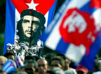 
Cubans hold a poster of Ernesto 