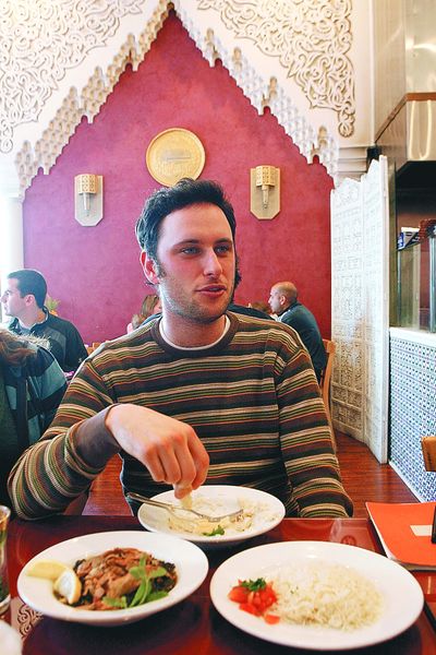 Noah Galuten eats Syrian food with friends at the Sham restaurant in Santa Monica, Calif., Dec. 12.  (Associated Press / The Spokesman-Review)