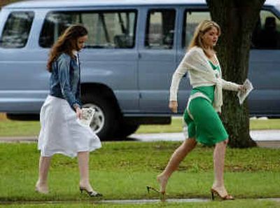 
President Bush's twin daughters Barbara, left, and Jenna, right, are careful not to step in puddles as they walk to their vehicle after attending Easter Church services with their family at Fort Hood, Texas on April 11. President Bush's twin daughters Barbara, left, and Jenna, right, are careful not to step in puddles as they walk to their vehicle after attending Easter Church services with their family at Fort Hood, Texas on April 11. 
 (File/Associated PressFile/Associated Press / The Spokesman-Review)
