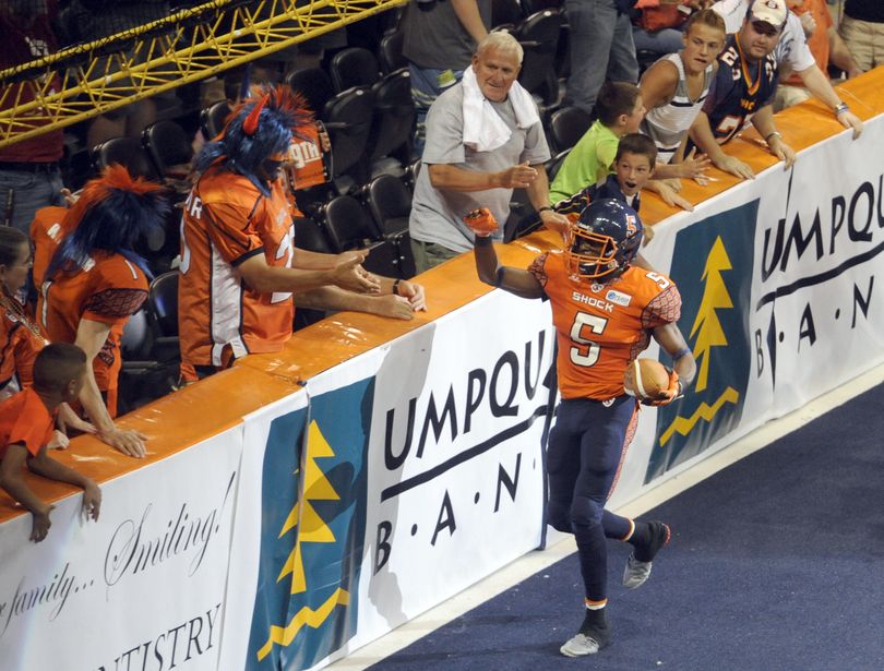 Terrance Sanders of the Spokane Shock runs over to celebrate with fans in the endzone after returning an interception for a touchdown. (Jesse Tinsley)