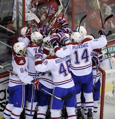 The Montreal Canadiens celebrate their shocking Game 7 victory over the top-seeded Washington Capitals in Washington. (Associated Press)