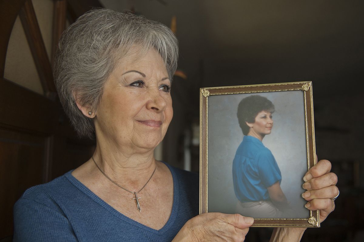 Shirley “Chich” Berger is seen last month at her Carmichael, Calif., home with a photograph from her early 40s. She started losing her hair in her mid-50s from menopause and family genes, and now goes to a hairstylist once a week to maintain the hair she has.