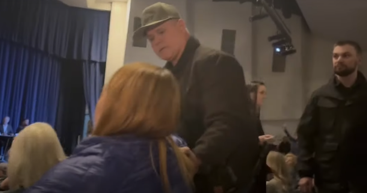 This screenshot from a video recording shows Kootenai County Sheriff Bob Norris grabbing the arm of Teresa Borrenpohl during a town hall meeting in February. (courtesy)