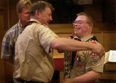 
Eagle Scout Chris Naccarato gets a congratulatory hug from his Scoutmaster Barry Larson. Larson was instrumental in helping Naccarato achieve his Eagle Scout. Naccarato's father Jay Naccarato, looks on from left. 
 (Liz Kishimoto / The Spokesman-Review)