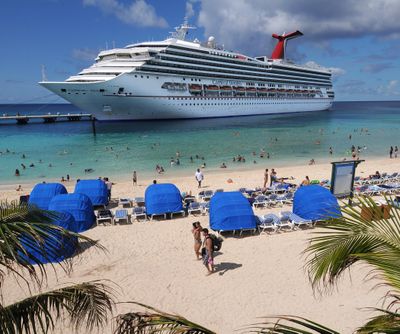 In this Oct. 8, 2008,  photo released by Carnival Corp. & plc, passengers aboard the Carnival Destiny enjoy the beach at the Grand Turk Cruise Terminal in Grand Turk, Turks and Caicos. (Andy Newman / Associated Press)