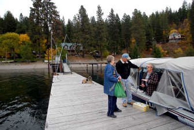 
John Thaxter, right, stops to chat with Whiskey Rock residents Shirley Williams, left, and Argyle Mydland while delivering mail.
 (JESSE TINSLEY PHotos / The Spokesman-Review)