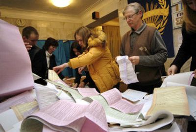 
Members of Ukraine's Central Election Commission sort out ballots at a polling station today in Kiev. 
 (Associated Press / The Spokesman-Review)