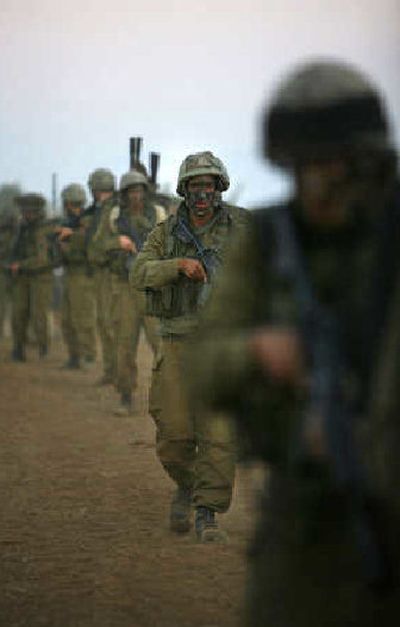 
Israeli soldiers march toward Lebanon from northern Israel on Wednesday. Israel launched its deepest ground strike into Lebanon. 
 (Associated Press / The Spokesman-Review)