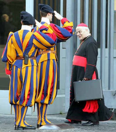 
Swiss guards salute Portuguese Cardinal Jose Saraiva Martins as he enters the Vatican on Friday on his way to attend a meeting of the College of Cardinals. The College of Cardinals is holding daily meetings ahead of a secret vote later this month to elect a successor to Pope John Paul II.
 (Associated Press / The Spokesman-Review)