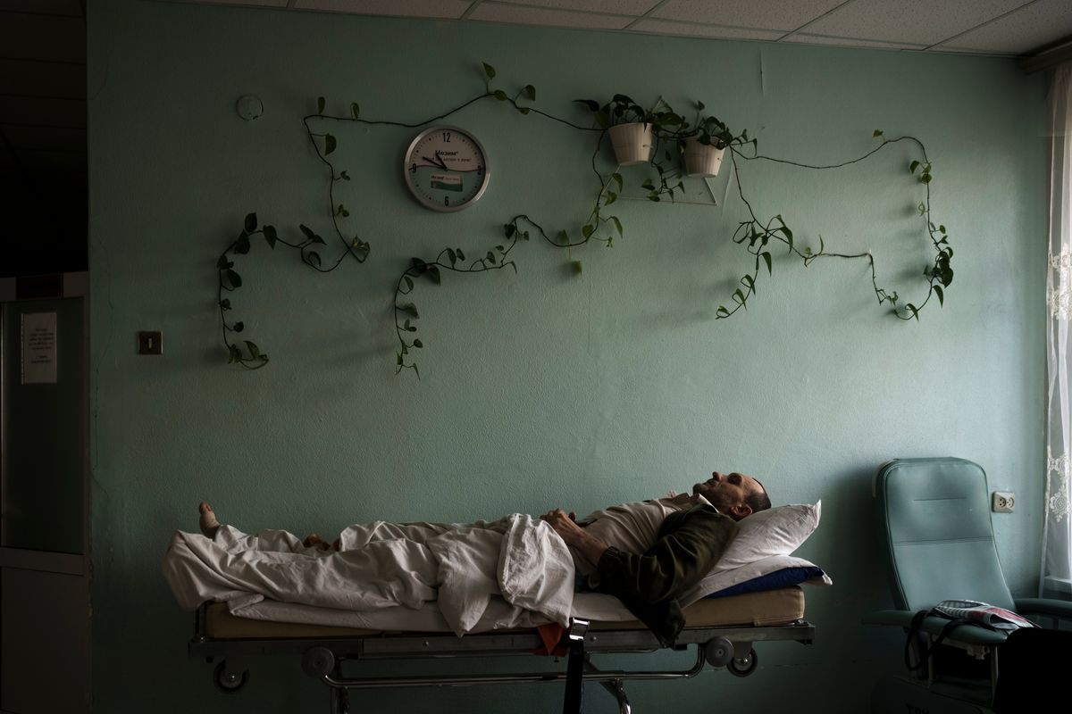 A man injured in a bombing lies on a stretcher at a hospital hallway on Thursday during an air raid alarm in Brovary, north of Kyiv, Ukraine.  (Felipe Dana)