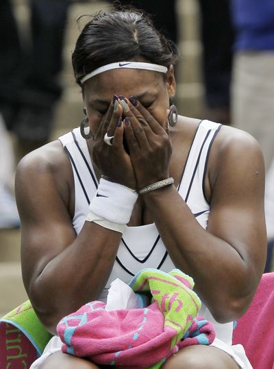 Serena Williams cries after defeating France’s Aravane Rezai in their first-round match at Wimbledon. It was her first appearance in a Grand Slam tournament in almost a year. (Associated Press)