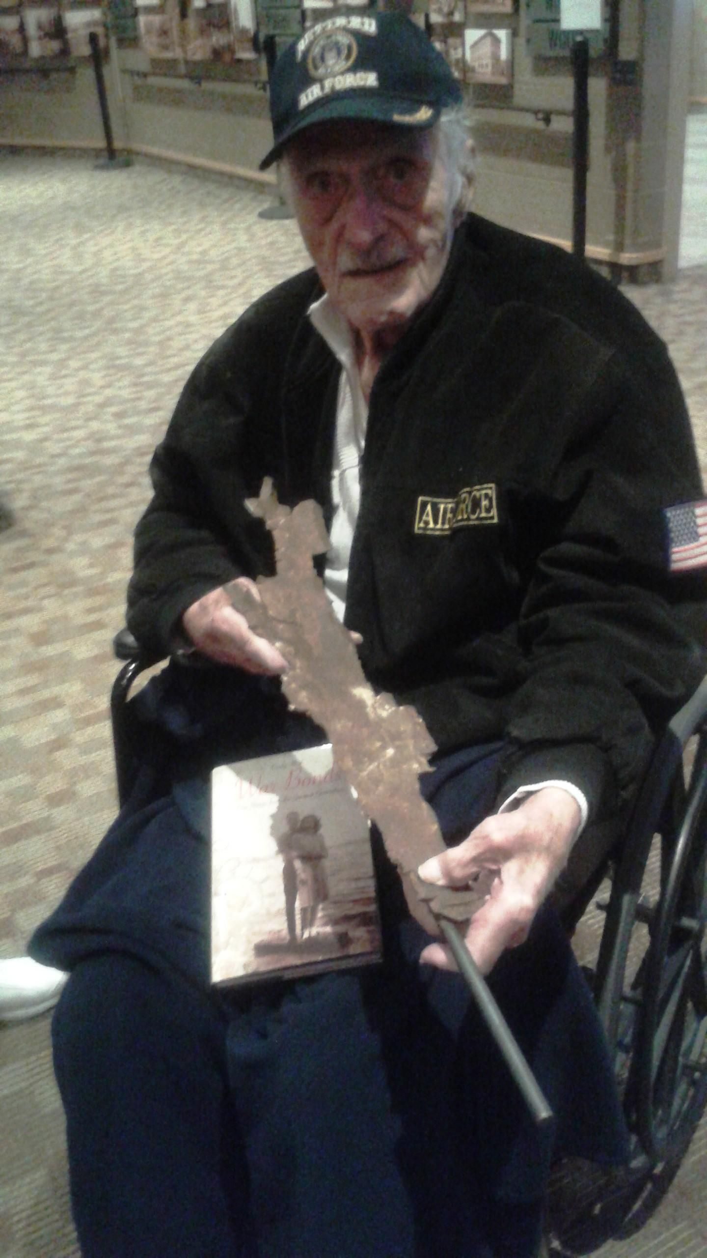 Nick Gaynos holding the piece of shrapnel that landed near him while under fire during the attack on Pearl Harbor 75 years ago. Gaynos died 20 days after this March 11, 2015, photograph. (Courtesy Cindy Hval)