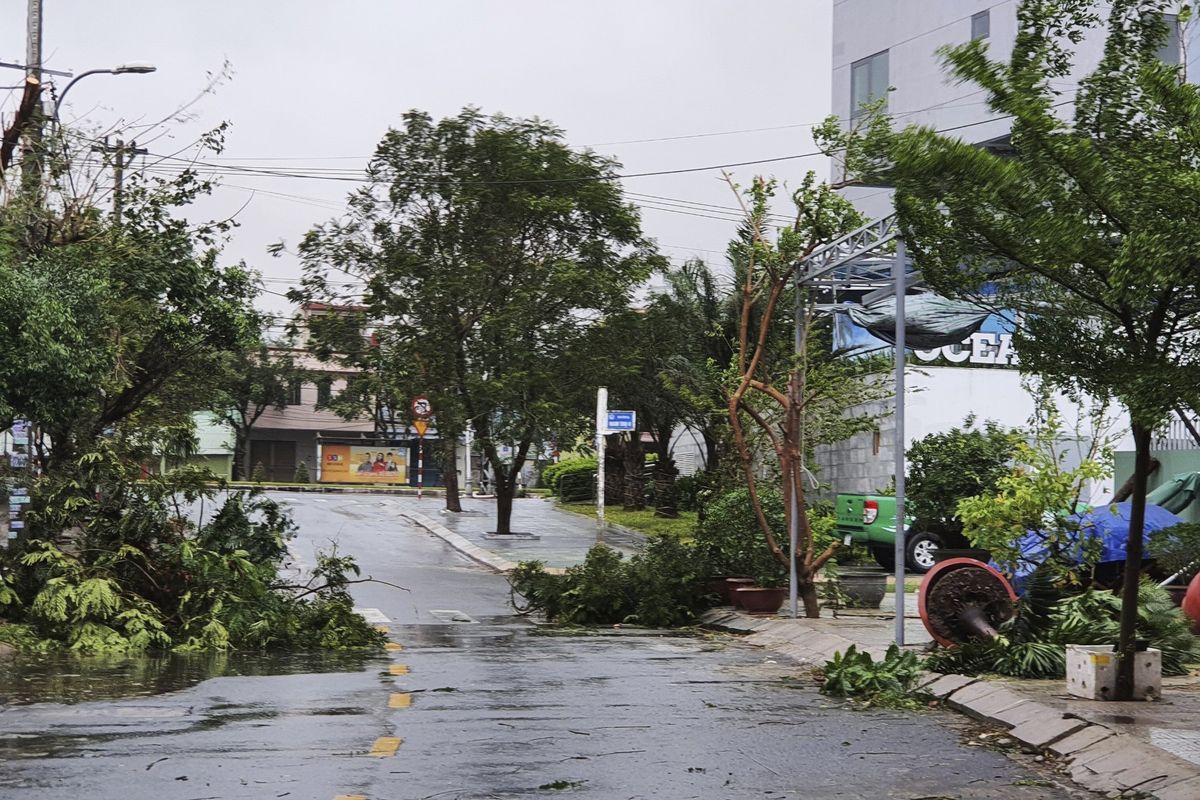 Broken tree branches caused by strong winds from typhoon Molave lie on a deserted street in Da Nang, Vietnam Wednesday, Oct. 28, 2020. Typhoon Malove sank a few fishing boats as it approached Vietnam