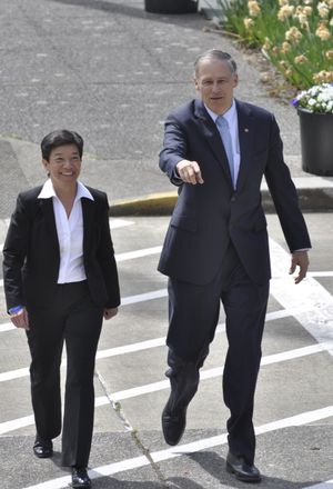 OLYMPIA -- Gov. Jay Inslee and King County Superior Court Judge Mary Yu arrive at the Temple of Justice Thursday where Inslee appointed Yu to fill an opening on the state Supreme Court.  (Jim Camden)