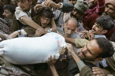 
Survivors of the Oct. 8 earthquake jostle for a bag of flour donated by the U.S. government near Bala Hattian in Pakistani Kashmir Tuesday. The U.N. World Food Program warned that half a million people have yet to receive relief supplies. 
 (Associated Press / The Spokesman-Review)