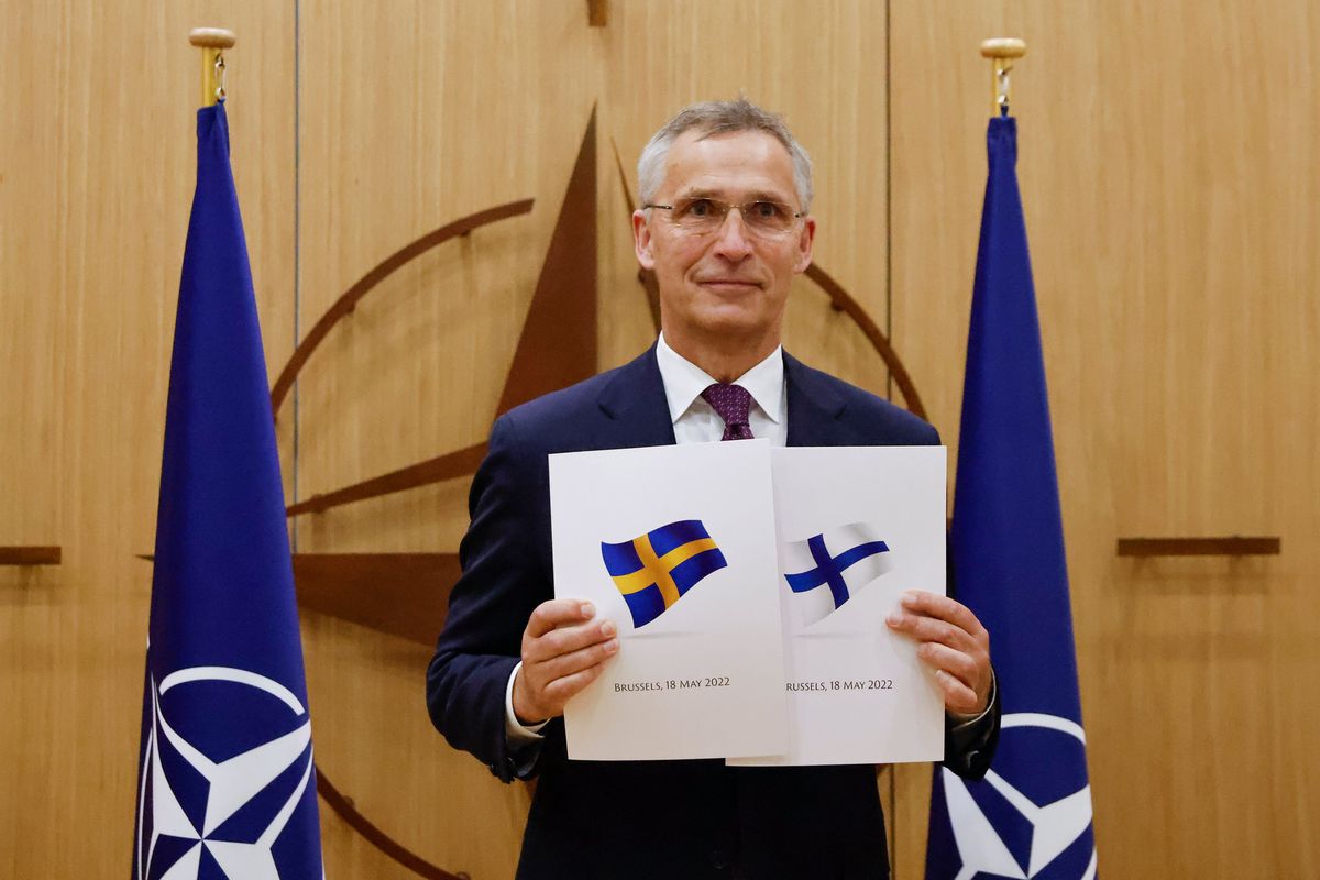 NATO Secretary-General Jens Stoltenberg displays documents as Sweden and Finland applied for membership in Brussels, Belgium, Wednesday May 18, 2022. NATO Secretary-General Jens Stoltenberg said that the military alliance stands ready to seize a historic moment and move quickly on allowing Finland and Sweden to join its ranks, after the two countries submitted their membership requests.  (JOHANNA GERON)