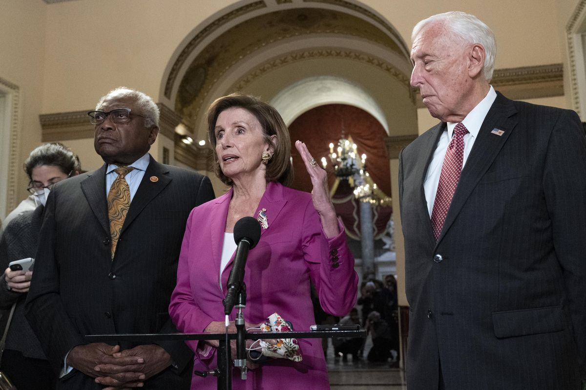 Speaker of the House Nancy Pelosi, D-Calif., accompanied by House Majority Whip James Clyburn, D-S.C., left, and House Majority Leader Steny Hoyer D-Md., speaks to reporters Friday at the Capitol in Washington, where the House approved President Joe Biden’s $1 trillion infrastructure package.  (Jose Luis Magana)