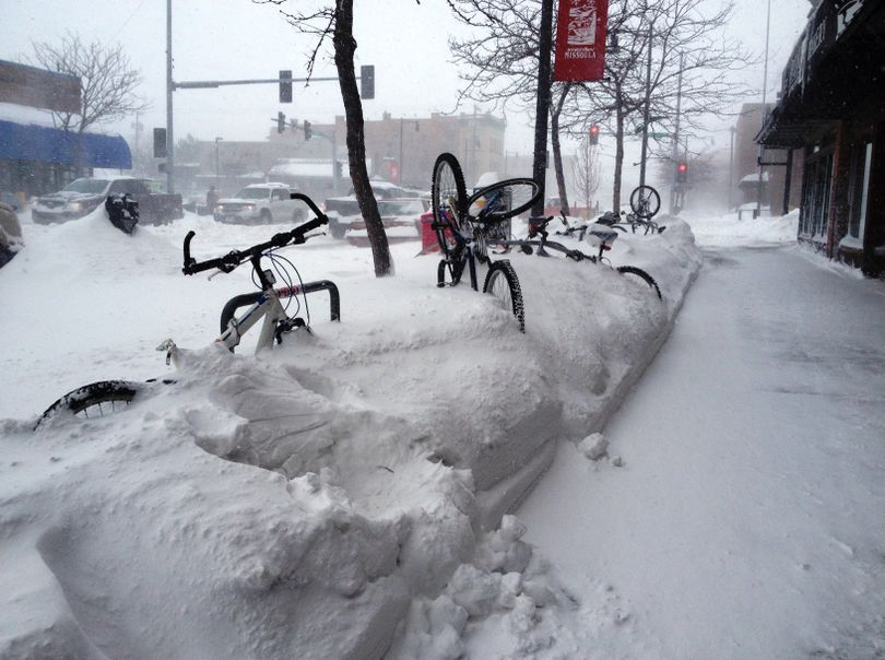 Bicycles are covered in snowdrifts Friday as much of downtown Missoula was deserted due to a snowstorm. (Associated Press)