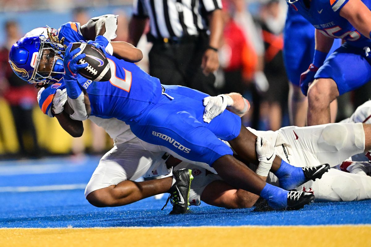 Boise State Broncos running back Ashton Jeanty (2) falls into the endzone for a touchdown despite being wrapped up by two Washington State Cougars during the first half of a college football game on Saturday, Sep. 28, 2024, at Albertsons Stadium in Boise, Id. Boise State led 17-10 at the half.  (Tyler Tjomsland/The Spokesman-Review)