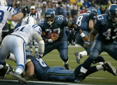 
Seattle's Shaun Alexander finds an opening on the way to a 1-yard touchdown run in the fourth quarter that tied him with  Priest Holmes for the most single-season TDs in NFL history (27).
 (Christopher Onstott/The Spokesman-Revier / The Spokesman-Review)