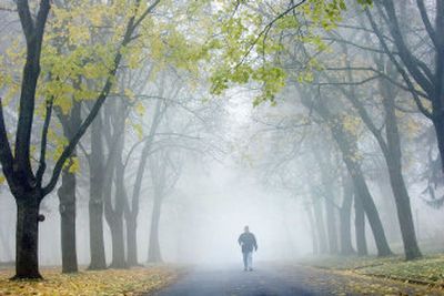
Kelly Watson walks in the fog on Manito Boulevard on Thursday morning. 