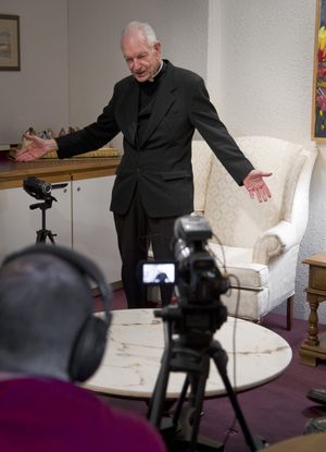 While being videotaped Dec. 8, the Rev. Armand Nigro tells a story from his early priesthood. John and Catherine Reimer are recording his memories for the Ministry Institute in Spokane. (Colin Mulvany)