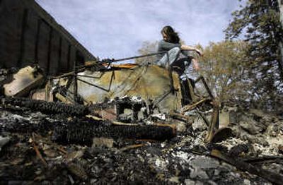 
Brandi Aurelio  looks over the remains of her home Sunday in Lake Arrowhead, Calif. Associated Press
 (Associated Press / The Spokesman-Review)