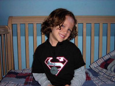 
Jordan Santiago poses in his room. He wears a medal he won in a competition at the International Modeling and Talent Association. He aspires to be a superhero or at least play one on TV. 
 (JENNIFER LARUE / The Spokesman-Review)