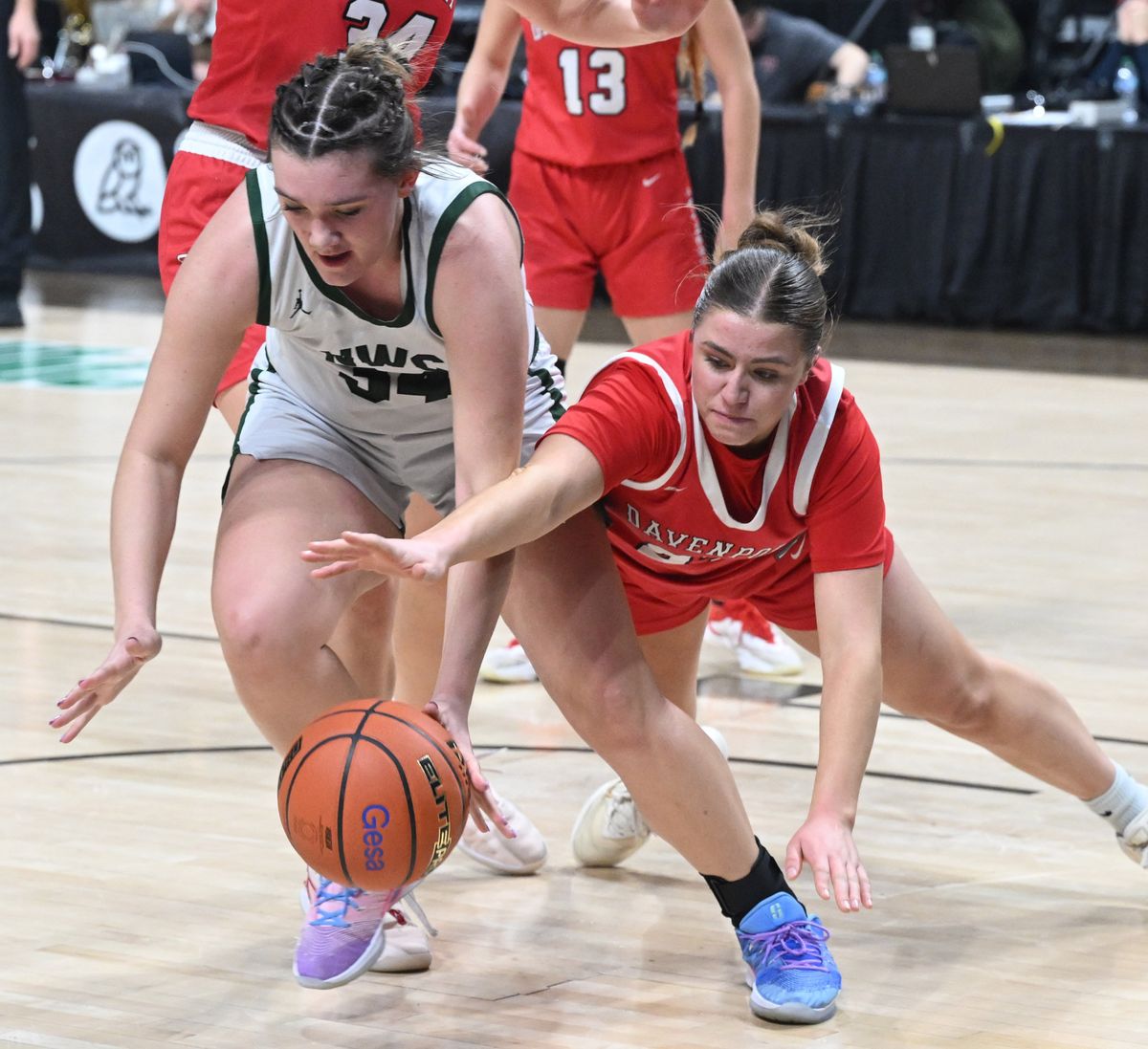 Northwest Christian’s Macey Shamblin, left, and Davenport’s Addie Schneider scramble after a rebound during their matchup in the Class 2B state girls basketball tournament on Thursday at the Arena.  (Jesse Tinsley/THE SPOKESMAN-REVI)
