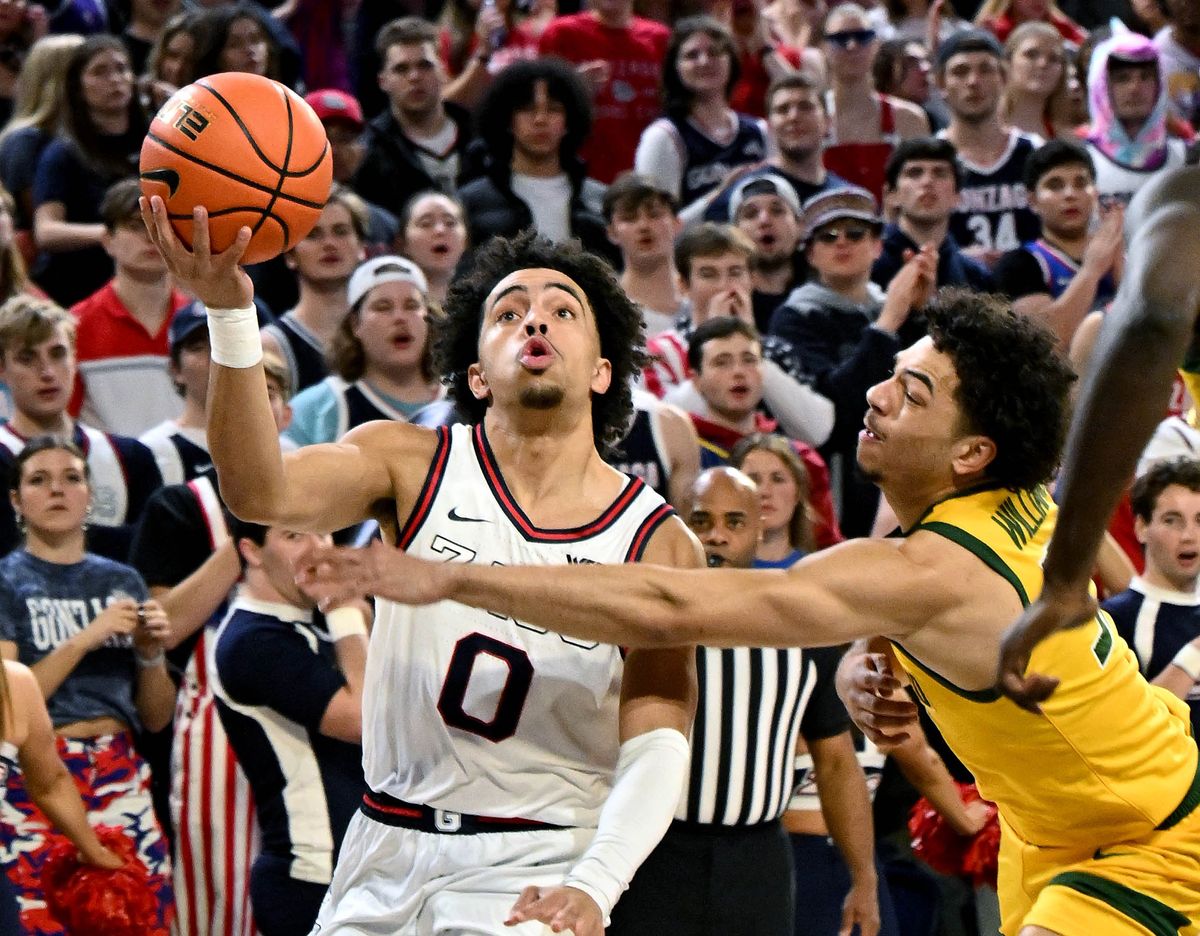 Gonzaga guard Ryan Nembhard (0) heads to the basket as San Francisco guard Marcus Williams (55) defends during the first half of a NCAA college basketball game, Thursday, Jan. 25, 2024, in the McCarthey Athletic Center.  (COLIN MULVANY)