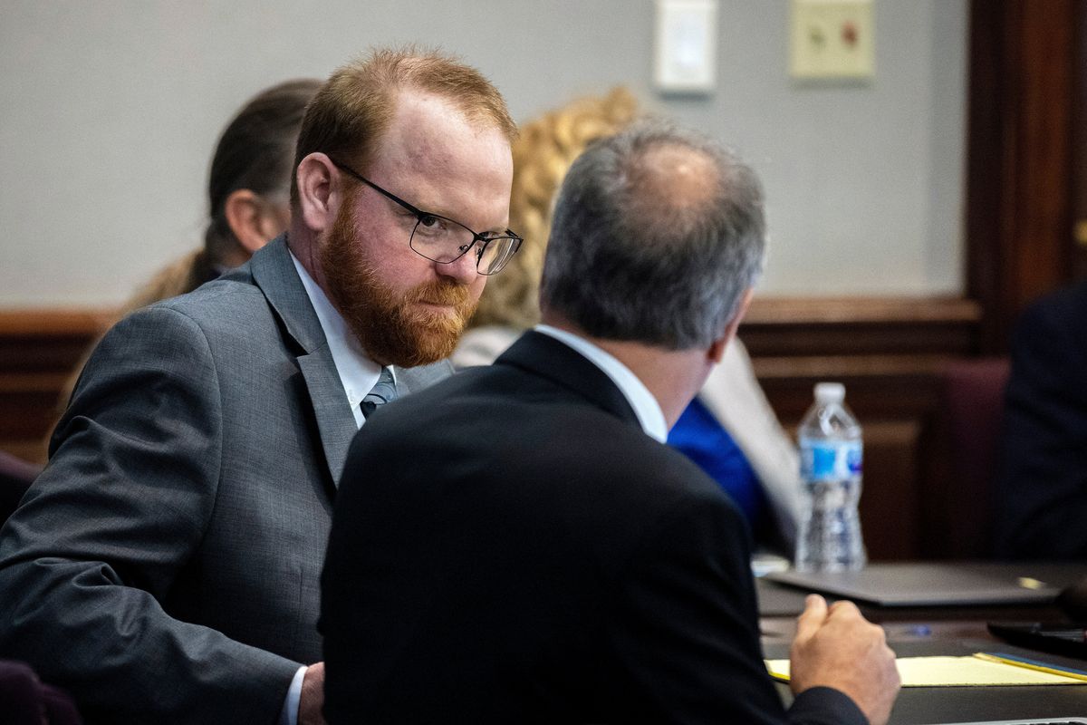 Defendant Travis McMichael speaks with his attorney Bob Rubin while they wait for the jury to return to the courtroom during the trial of McMichel and his father, Greg McMichael, and a neighbor, William "Roddie" Bryan in the Glynn County Courthouse, Wednesday, Nov. 24, 2021, in Brunswick, Ga. The three are charged with the February 2020 slaying of 25-year-old Ahmaud Arbery.  (Stephen B. Morton)