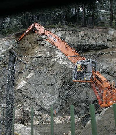 
A hydraulic hammer is used to remove loose rock in a rockslide area on I-90 near Hyak, Wash., on Tuesday. 
 (Associated Press / The Spokesman-Review)