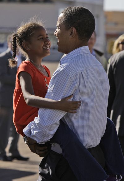 President-elect Barack Obama, carries his daughter Sasha, 7, in this file photo. Obama’s election has made the dream of becoming president seem more real to many kids.FILE  (FILE Associated Press / The Spokesman-Review)