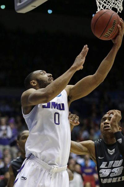 A.J. Davis scores two of his 20 points for James Madison. (Associated Press)