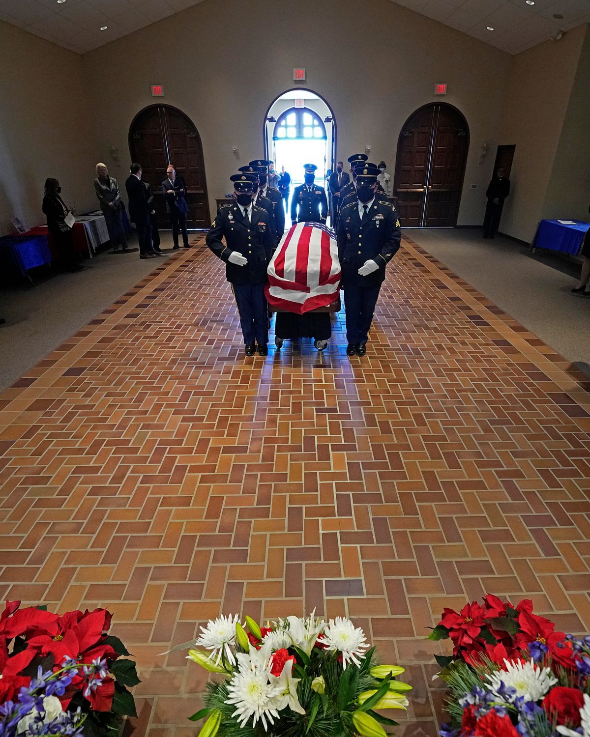 Pallbearers move a casket holding former Sen. Bob Dole, R-Kan., during a memorial service in Dole