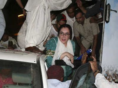 
Bhutto is rescued from her truck after two-bomb explosions in Karachi, Pakistan, early today.
 (Associated Press / The Spokesman-Review)
