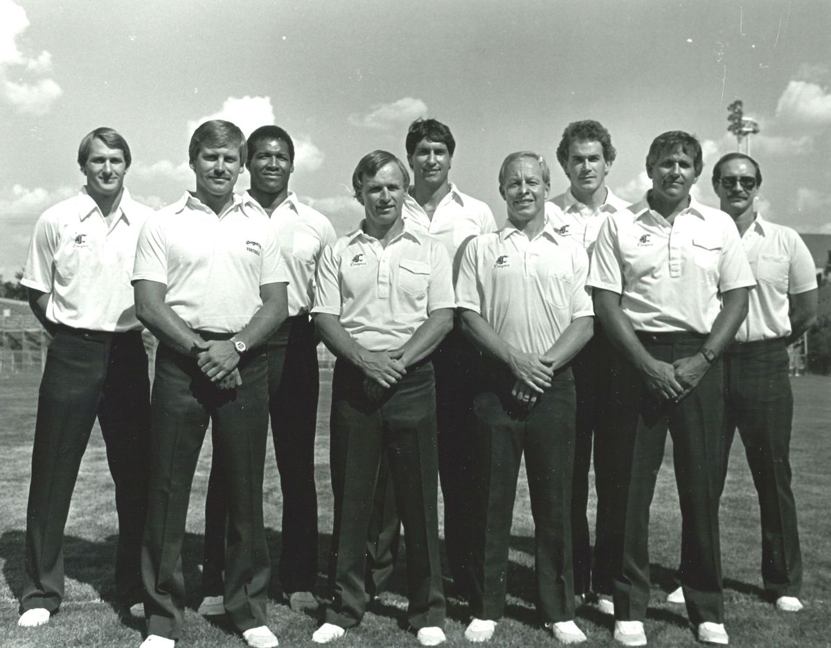 A photo of Washington State’s coaching staff in 1986 includes Jimmy Burrow (front row, far left), who was then the Cougars’ defensive back. Burrow, who spent six seasons in Pullman, is the father of Super Bowl-bound Cincinnati Bengals quarterback Joe Burrow.  (WSU Athletics/Courtesy)