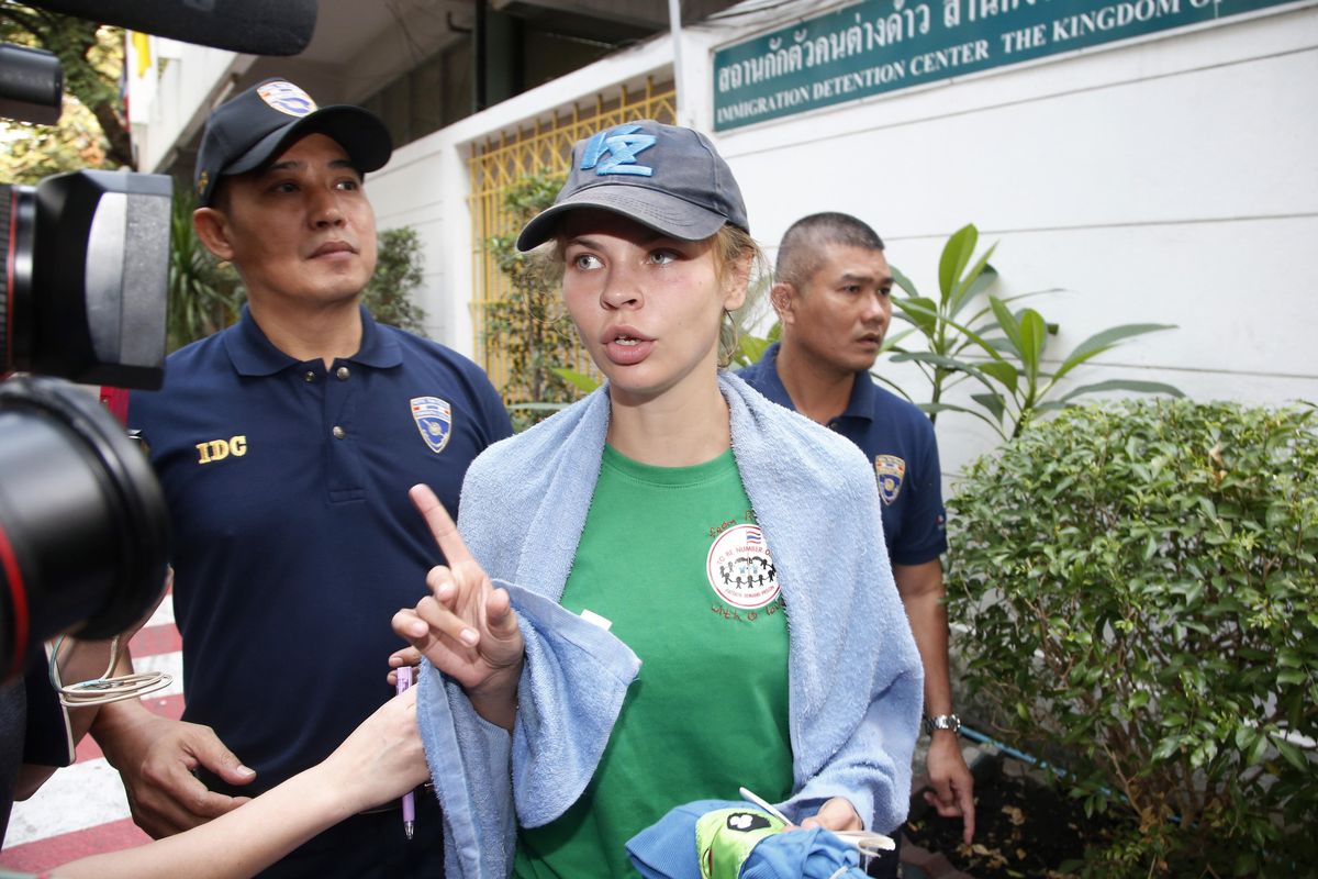 Belarusian model Anastasia Vashukevich talks to journalists as she is escorted from the Immigration Detention Center toward a vehicle to take her to an airport for deportation in Bangkok, Thailand, Thursday, Jan. 17, 2019. Thai officials said they are deporting Vashukevich who claimed last year that she had evidence of Russian involvement in helping elect Donald Trump president. (Sakchai Lalit / Associated Press)