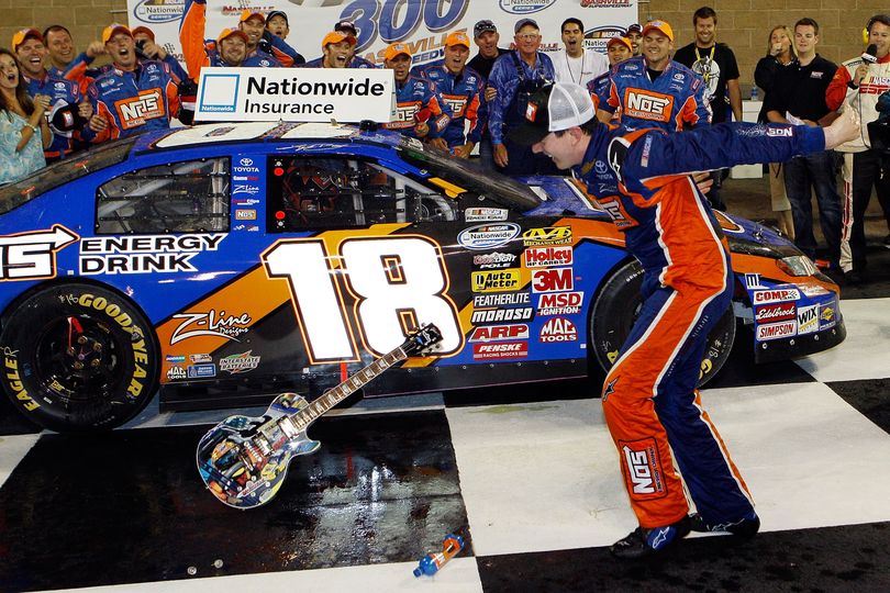 Kyle Busch, driver of the #18 NOS Energy Drink Toyota celebrates by smashing the Gibson Guitar given to the winner after winning the NASCAR Nationwide Series Federated Auto Parts 300 at the Nashville Superspeedway. (Photo Credit: Chris Graythen/Getty Images for NASCAR) (Chris Graythen / The Spokesman-Review)