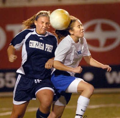 
Gonzaga Prep's Aubrey Bot, left, battles Mead's Marissa Mykines for control Wednesday night. 
 (Brian Plonka / The Spokesman-Review)