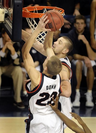 Micah Downs, left, and Josh Heytvelt of Gonzaga crash the offensive boards against San Francisco  during their game Saturday, Jan. 17, 2009, in Spokane. Downs controlled this rebound and got the putback for a score. (Christopher Anderson / The Spokesman-Review)