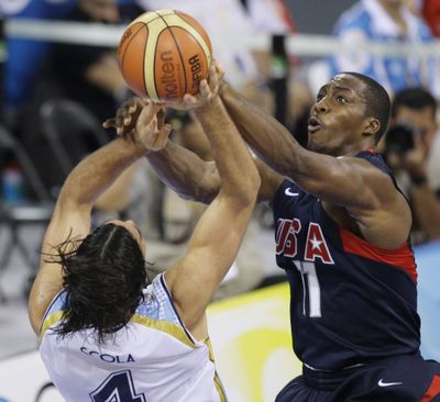 Associated Press USA center Dwight Howard, right, blocks a shot by Argentina’s Luis Scola in their semifinal game, a U.S. win. (Associated Press / The Spokesman-Review)