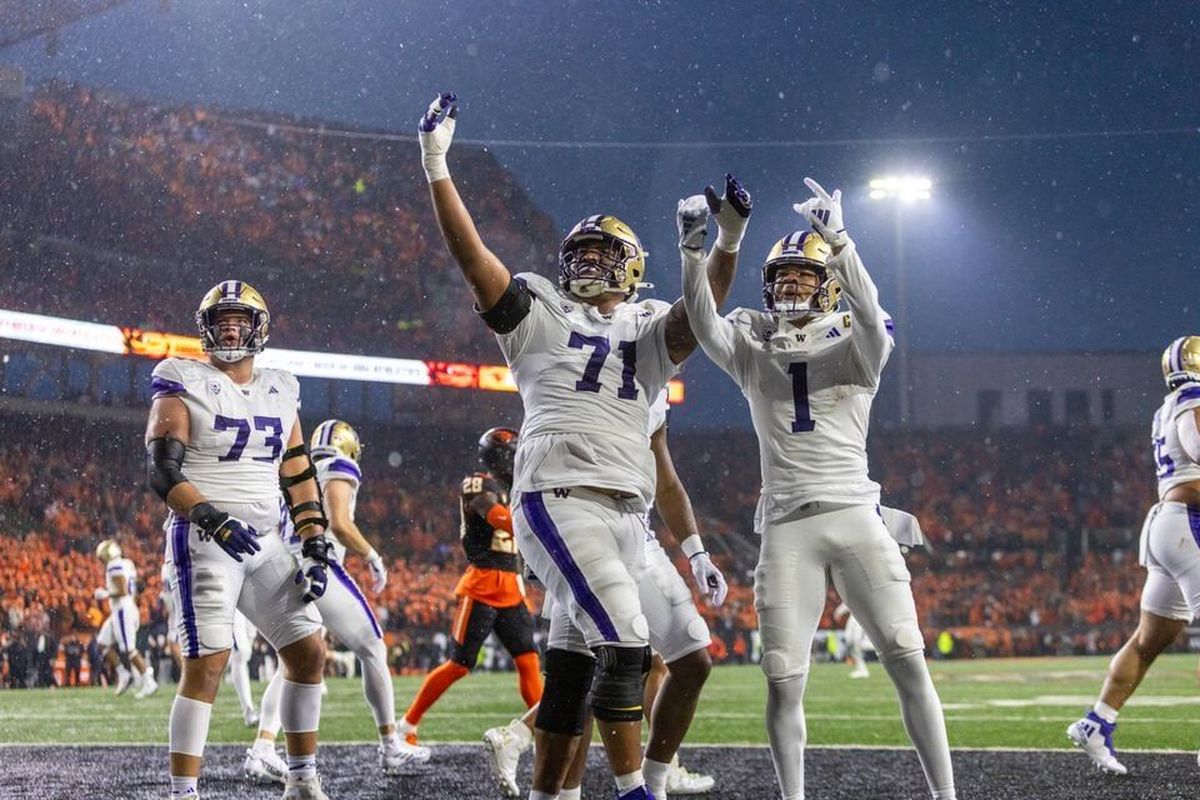 Washington wide receiver Rome Odunze (#1) celebrates his touchdown catch with offensive lineman Nate Kalepo (#71) as the No. 5 Huskies face the No. 11 Oregon State Beavers in a college football game at Reser Stadium in Corvallis, Oregon on Saturday, Nov. 18, 2023.  (Sean Meagher)