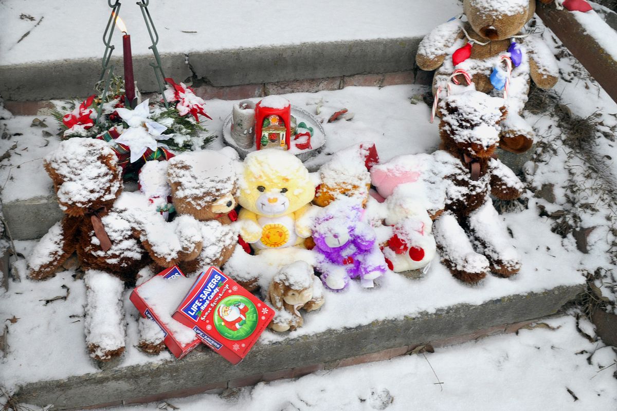 chrisa@spokesman.com Snow-covered toys, candy and a lighted candle sit on steps leading to the Old Curlew School Apartments in Curlew, Wash., on Tuesday. A fire destroyed the building and killed three people just before Christmas. (Christopher Anderson)