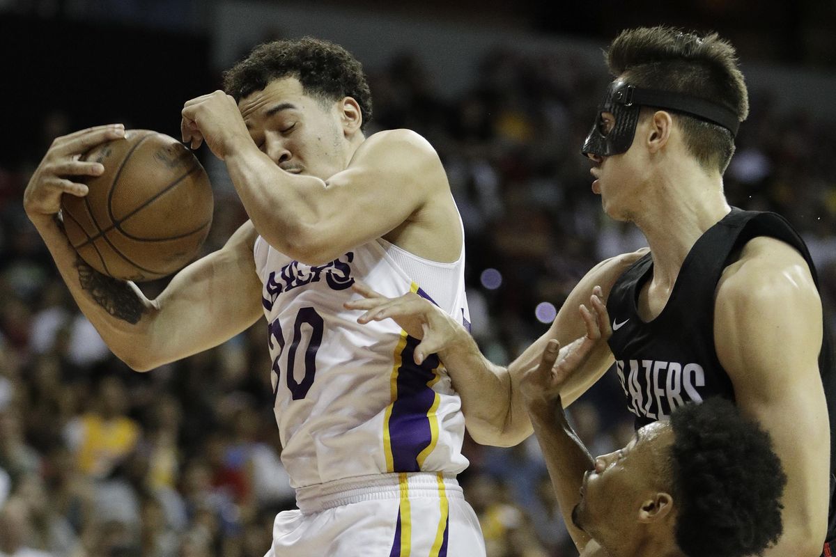 Portland Trail Blazers’ Zach Collins, right, fouls Los Angeles Lakers’ Jeffrey Carroll during the first half of an NBA Summer League game Tuesday in Las Vegas. (John Locher / AP)